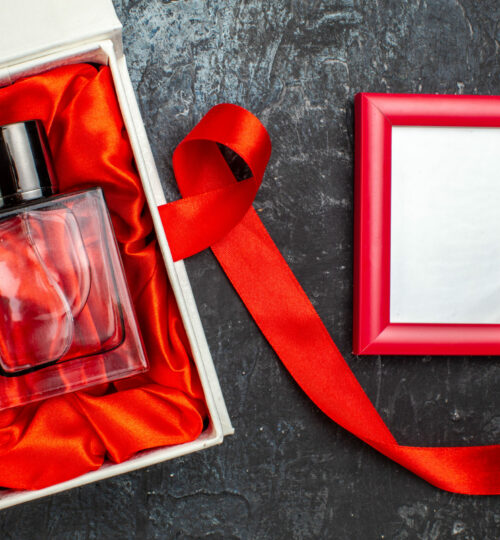 top-view-of-woman-perfume-on-gift-box-and-blue-rib-2021-08-30-18-56-28-utc